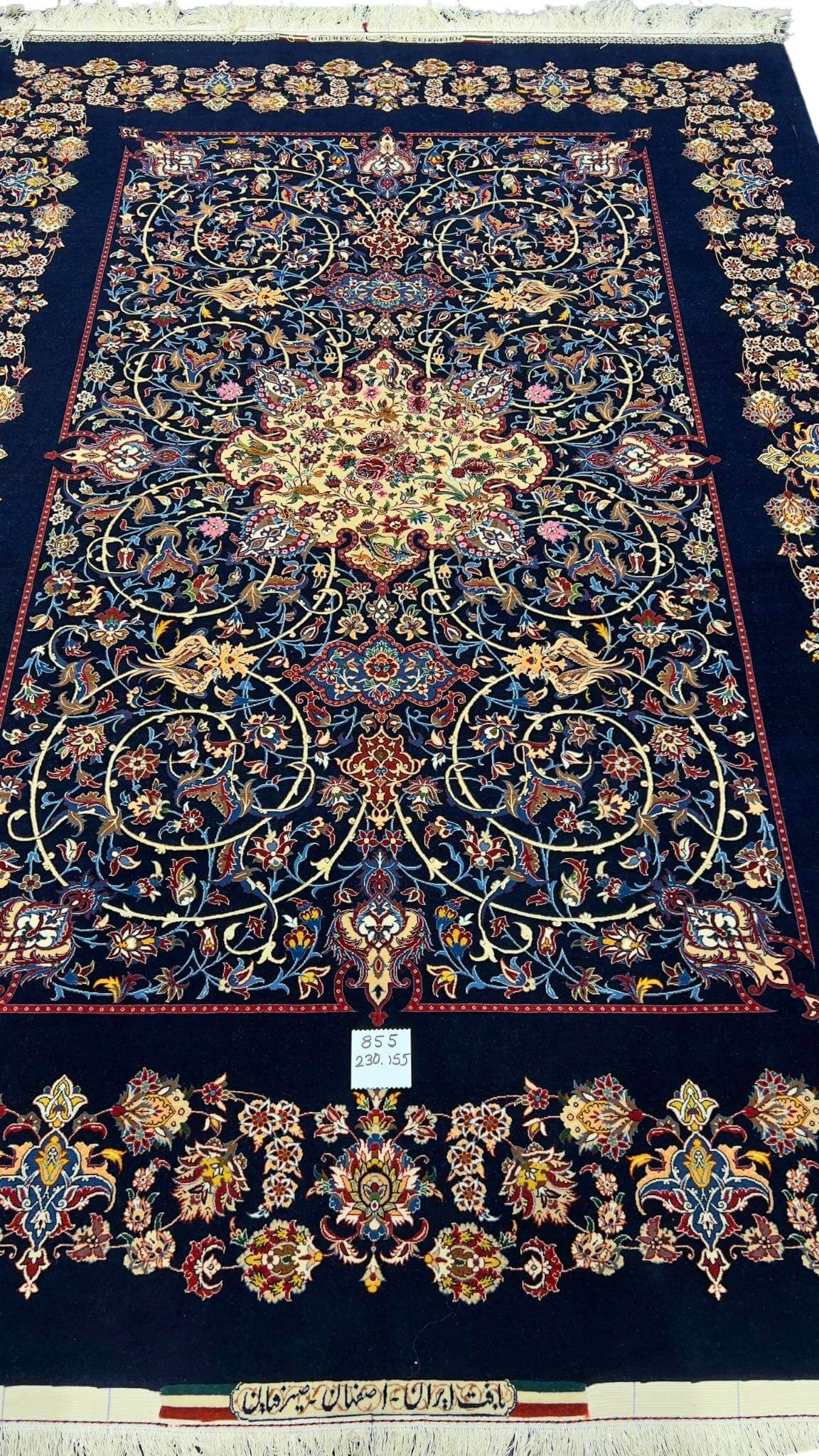 "Hand-knotted Isfahan Persian rug in navy blue with silk and wool pile."